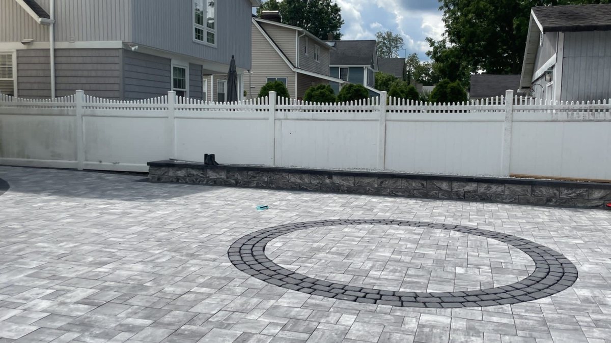 Completed circular paver patio with decorative center pattern by RMR & Brothers